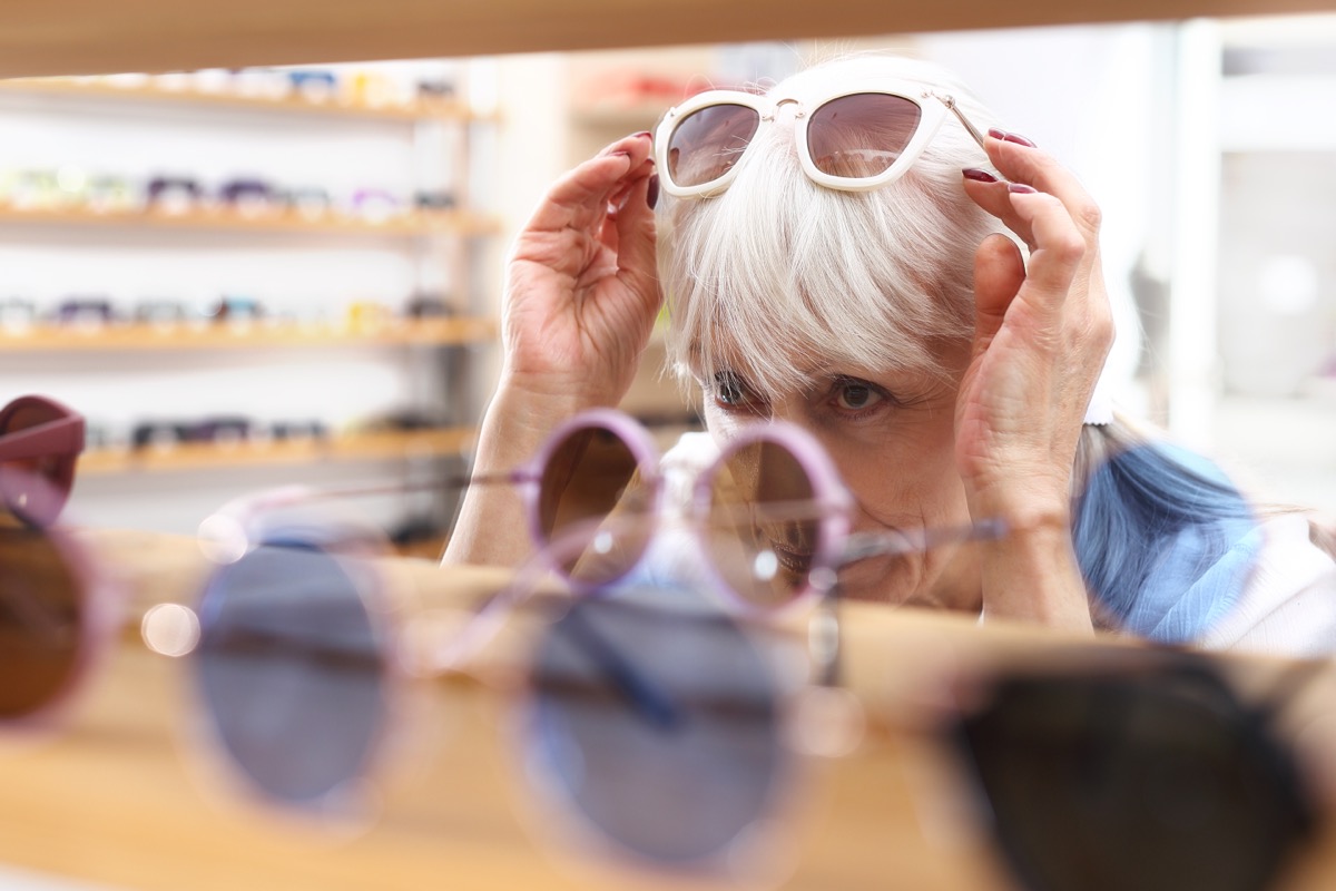 Senior woman buying sunglasses