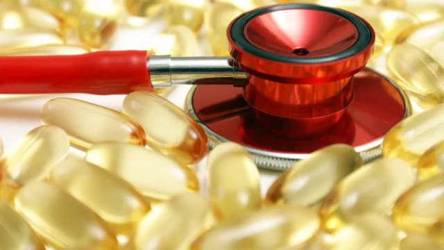 A,Macro,Shot,Of,A,Stethoscope,And,Omega 3,Supplements,To