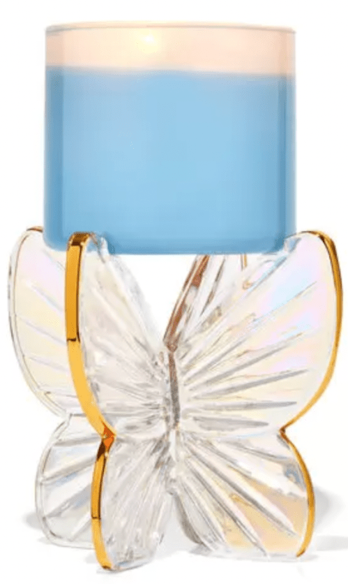 Product shot of Bath & Body Works glass butterfly candle holder with blue candle