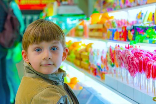 little boy looking exciting in a candy store
