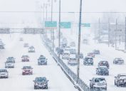 Cars driving on the highway during a snowstorm