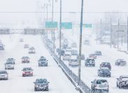 Cars driving on the highway during a snowstorm