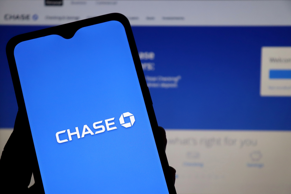 Close up of a phone with the Chase bank logo against a computer screen