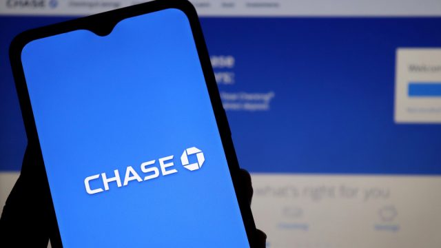 Close up of a phone with the Chase bank logo against a computer screen