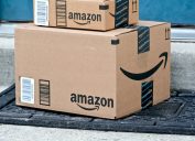Close up of a big and a small Amazon box piled outside a door