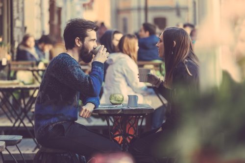 hipster man and woman on a first date at a cafe