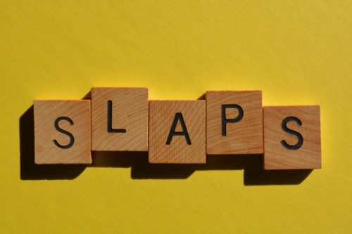 block letters spelling out "slaps," a gen-z slang word.