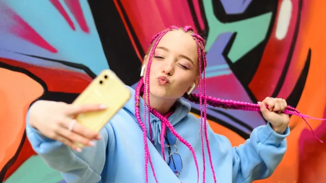 a pink-haired member of gen-z taking a selfie