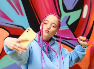 a pink-haired member of gen-z taking a selfie