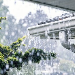 Gutters on a house overflowing during a torrential rain storm
