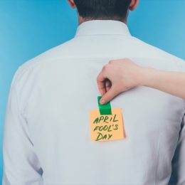 woman pulling a harmless april fools prank on her co-worker