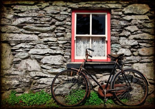 rural irish cottage with bicycle leaning against exterior