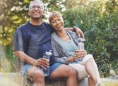 Nature, hiking and portrait of a senior couple resting while doing outdoor walk for exercise. Happy, smile and elderly man and woman in retirement trekking together for wellness in a forest in Brazil