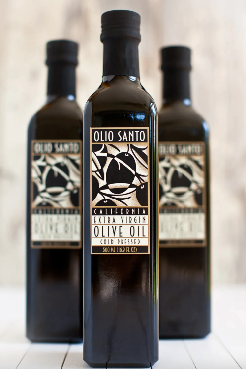 Three bottles of Olio Santo extra virgin olive oil