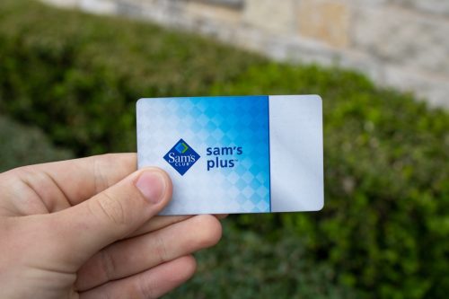 San Antonio, TX / USA - Mar. 03, 2020: A hand holds a Sam's Club Plus Member membership card, which gives users access to Sam's Club warehouse shopping, rewards, cheap food courts, and chicken