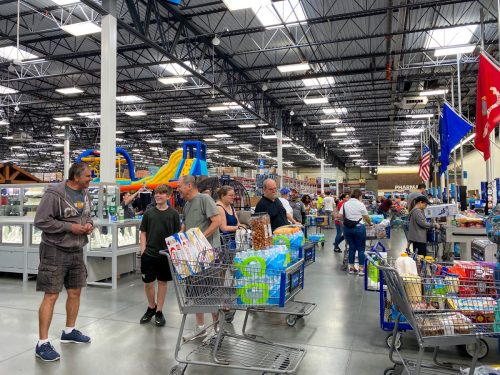 Orlando,FL/USA-3/14/20: Customers waiting in long lines to check out their groceries at a Sams Club in Orlando, Florida due to the hoarding of food and supplies during the coronavirus pandemic.