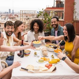 Group of diverse friends laughing at a dinner party
