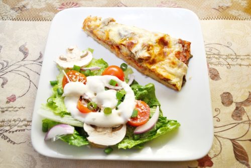 pizza and side salad on a plate