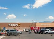 Albuquerque, New Mexico, USA - June 27, 2011: People with shopping carts on the parking lot of the North West Albuquerque Walmart Super-center. Coca-Cola delivery truck parked in front of the store. Picture taken midday.