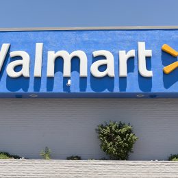 Close up of the Walmart logo on a storefront on a sunny day