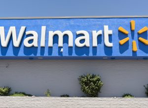 Close up of the Walmart logo on a storefront on a sunny day