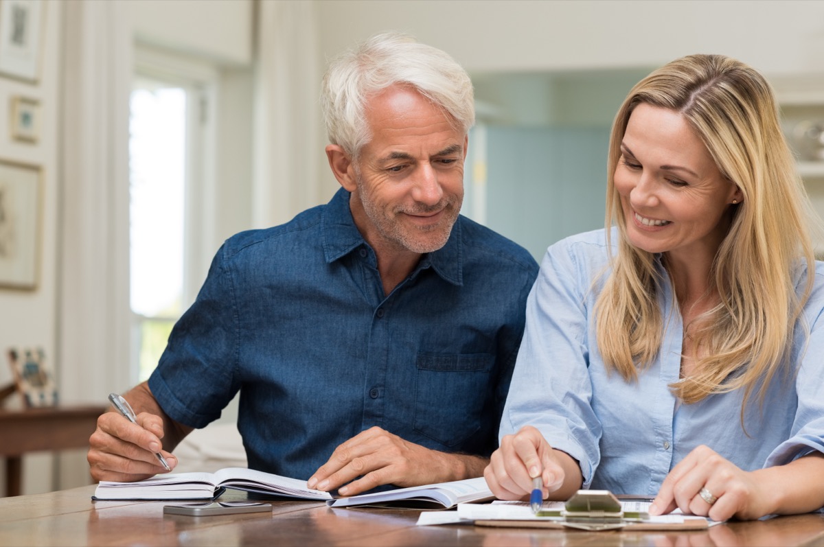 Mature couple reviewing documents at home