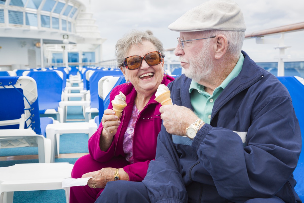 Happy senior couple having an ice cream on cruise ship deck