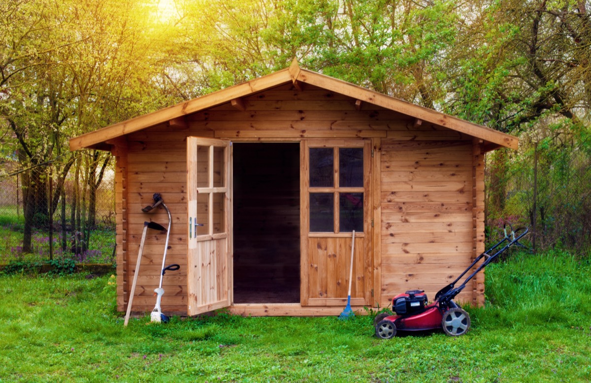 A wooden shed in a backyard