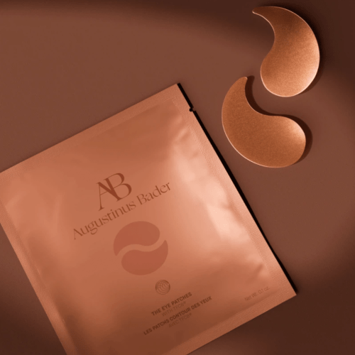 Augustinus Bader gold eye patches and packaging on brown background