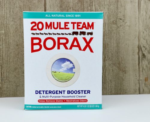 Box of Borax on white surface with wood background