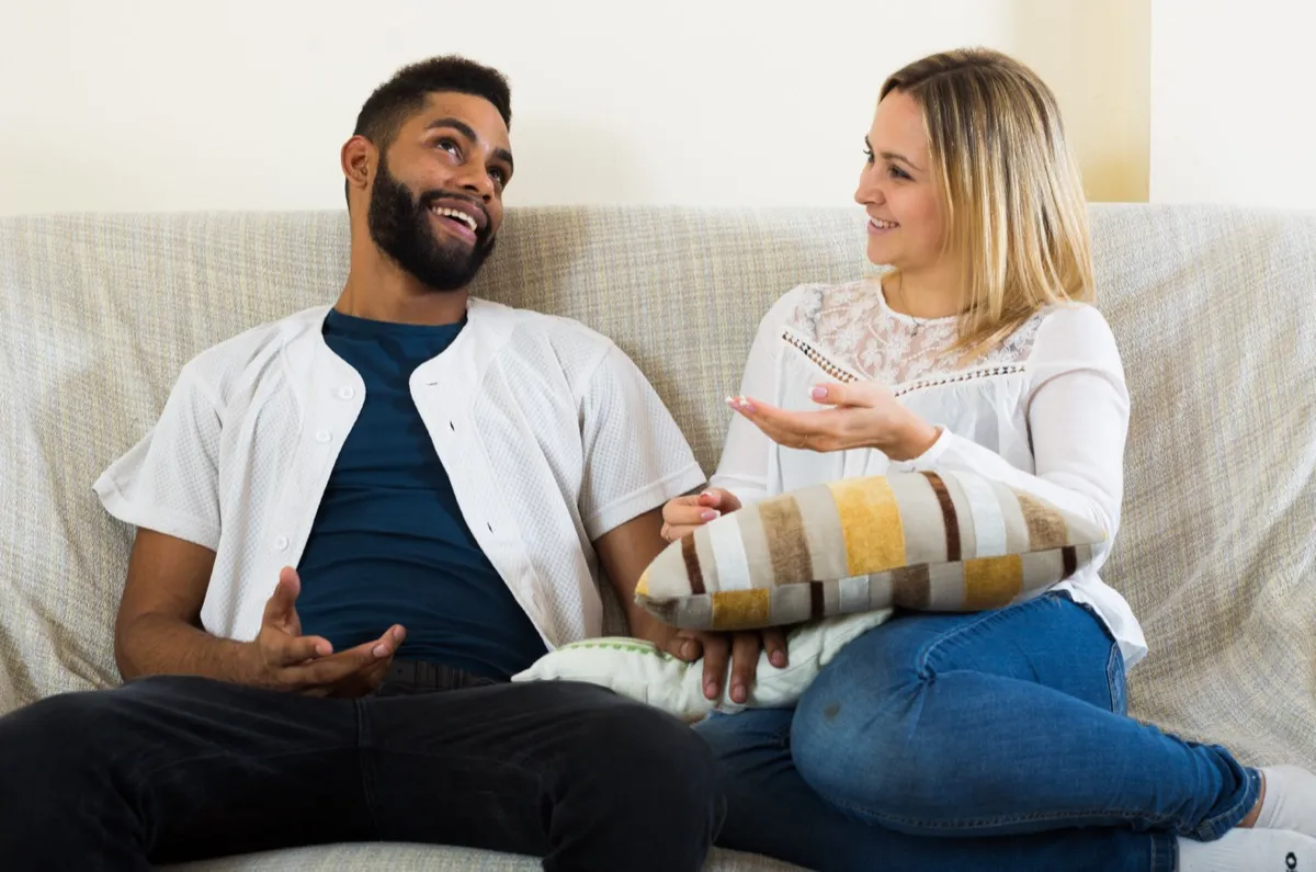 Man and woman having conversation on a couch