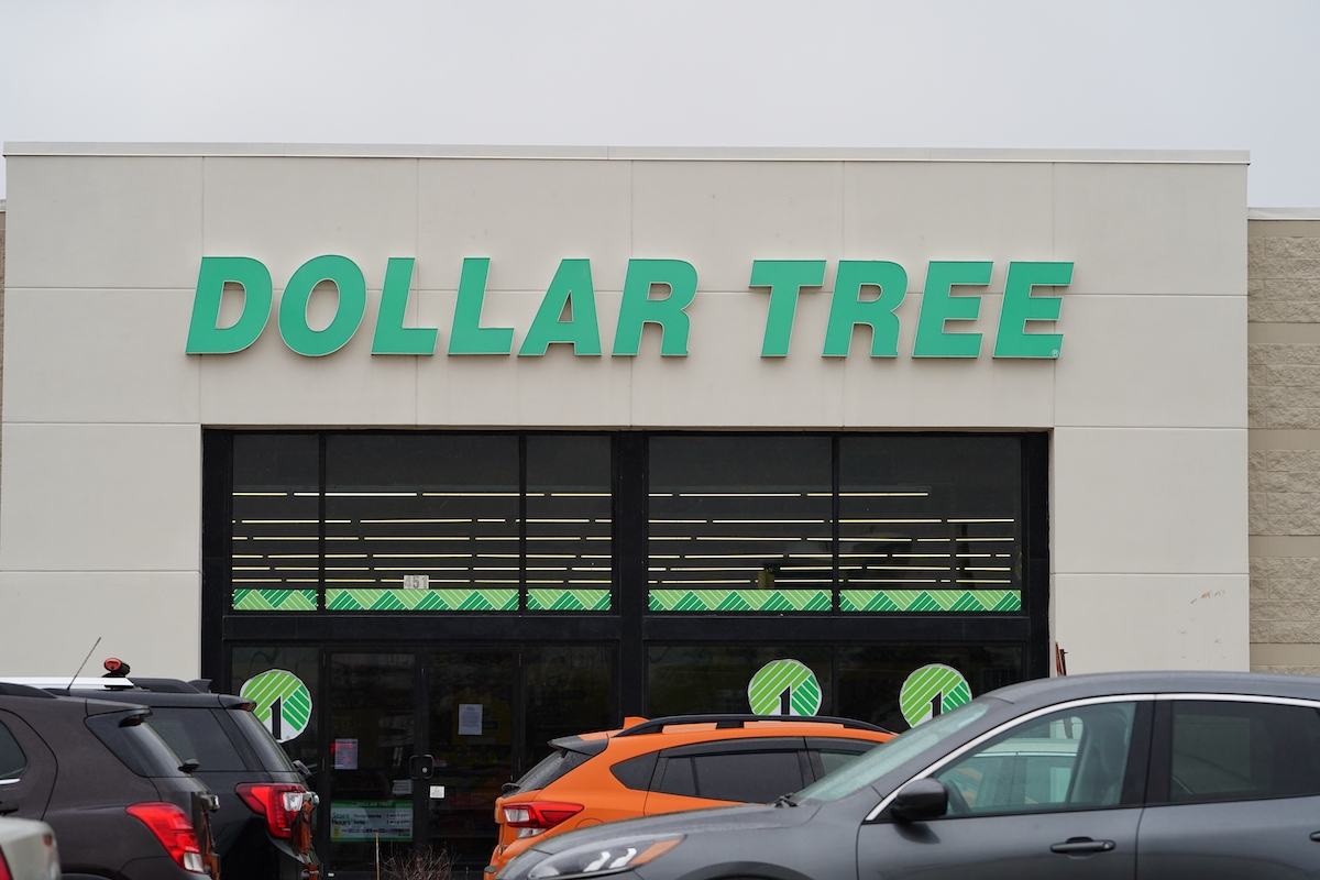 Close up of a Dollar Tree storefront with cars parked in front