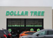 Close up of a Dollar Tree storefront with cars parked in front