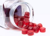 Organic Vegan Gummy vitamins for children coming out of the plastic jar