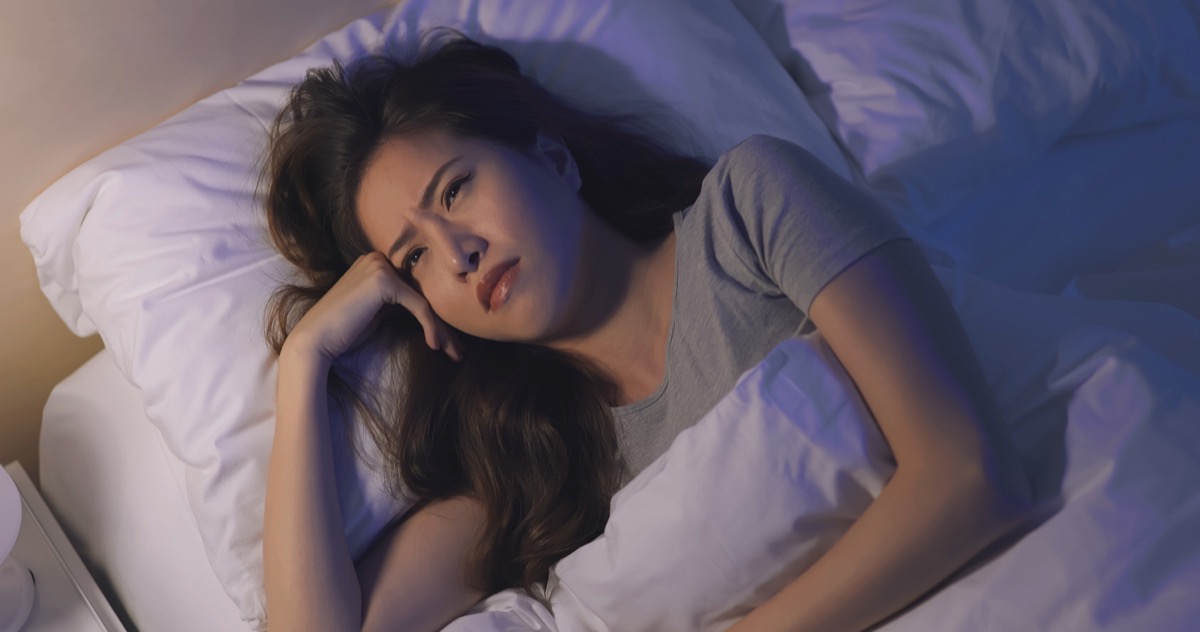 close up of woman anxious and unable sleep in the bed at night