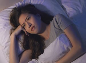 close up of woman anxious and unable sleep in the bed at night