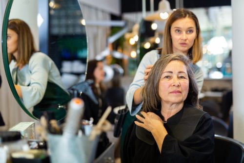 woman talking to hair stylist