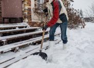 man shoveling snow from front steps