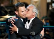 chevy chase kissing joel mchale on the cheek at the comedy awards