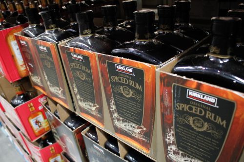 several cases of Kirkland Signature spiced rum, on display at a local Costco store.