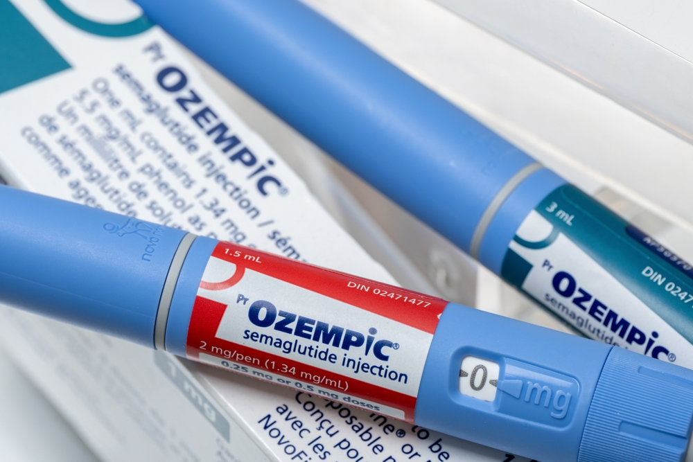 A close up of two Ozempic injectors on top of a product box