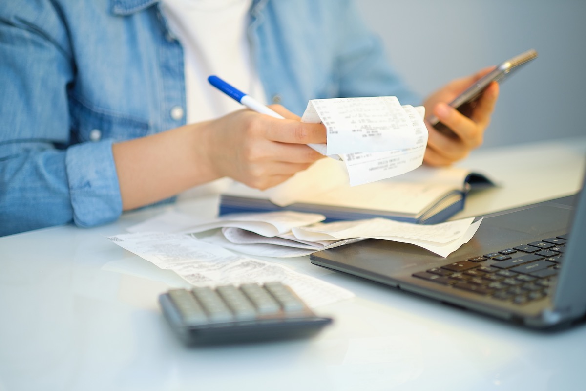 woman filing taxes looking at receipts