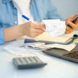 woman filing taxes looking at receipts