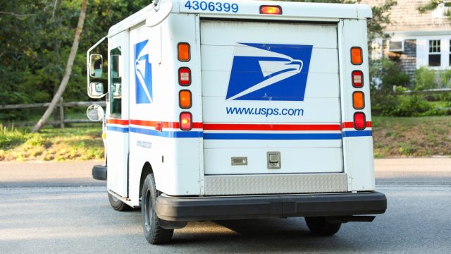 USPS mail truck turning on the street