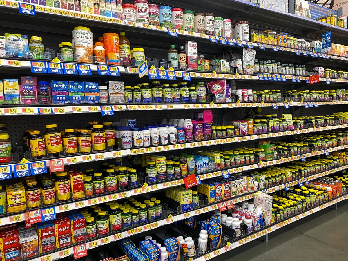 The Vitamin and Supplement aisle of a Walmart Superstore with a variety of supplemental pill and capsule products from various manufacturers.