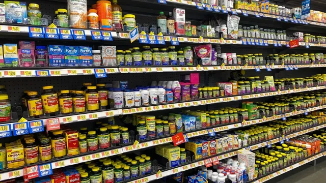 The Vitamin and Supplement aisle of a Walmart Superstore with a variety of supplemental pill and capsule products from various manufacturers.
