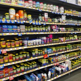 The Vitamin and Supplement aisle of a Walmart Superstore with a variety of supplemental pill and capsule products from various manufacturers.