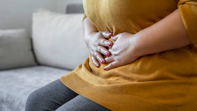 A close up of a person holding their stomach