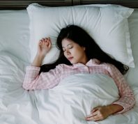 brown noise - overhead shot of a woman sleeping soundly in bed