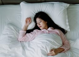 brown noise - overhead shot of a woman sleeping soundly in bed